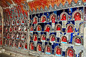 Myanmar, Burma, Nyaungshwe. Small Buddhas set into the temple wall, Shwe Yaunghwe Kyaung monastery, near Inle Lake. 